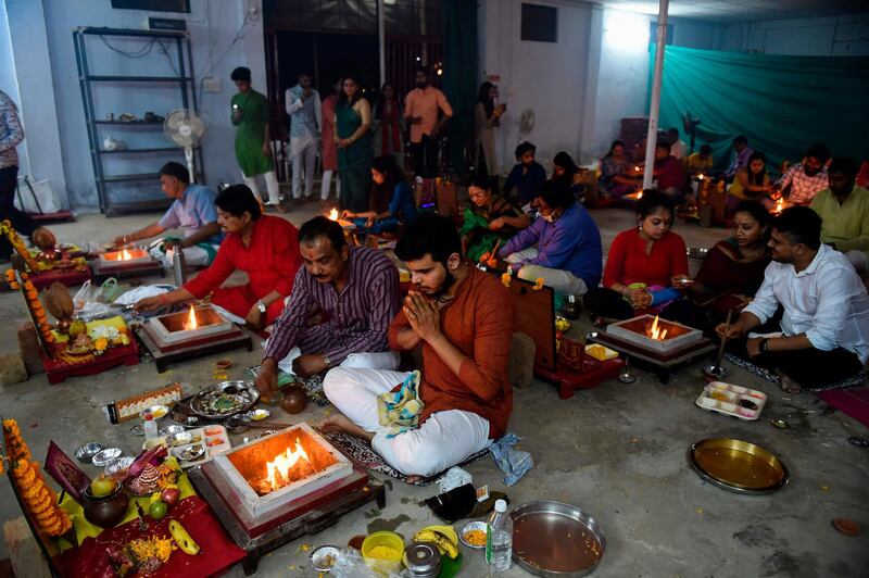 Hindu devotees take part in rituals on the occasion of Diwali, the Hindu festival of Lights, at Vejalpur village, on the outskirts of Ahmedabad.   AFP