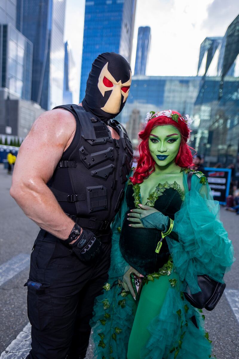 Cosplayers as Bane, left, and Poison Ivy pose during New York Comic Con. Charles Sykes / Invision / AP