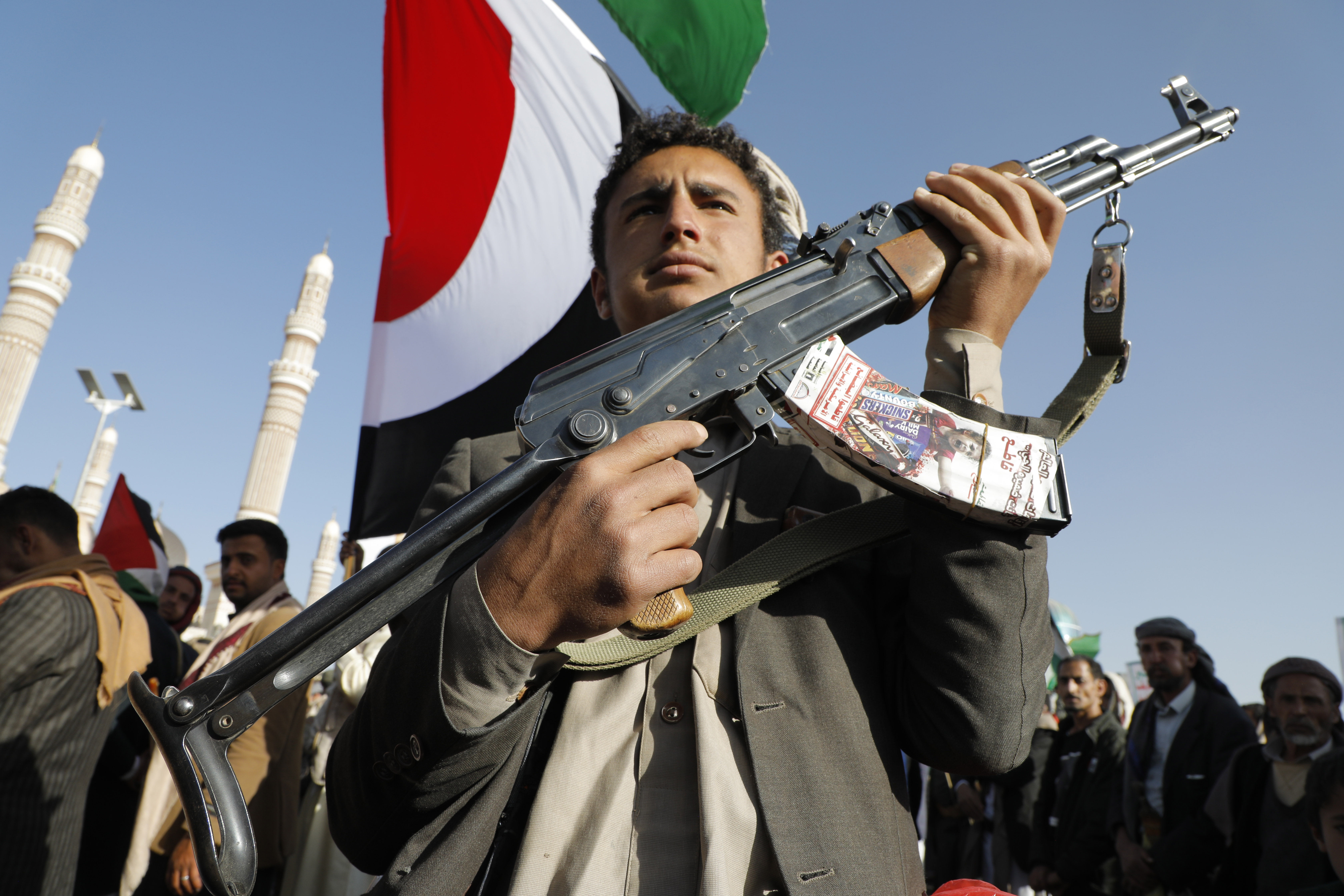 A man holds a gun during a protest in Yemen against the operation to safeguard trade and protect ships in the Red Sea. EPA