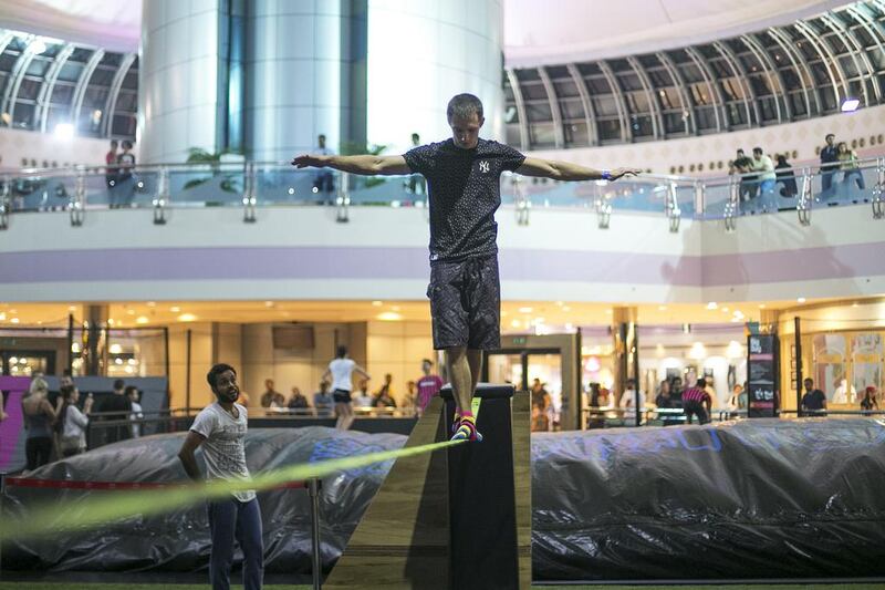 A man walks a tightrope at the opening of Bounce Abu Dhabi in Marina Mall.  Mona Al Marzooqi / The National