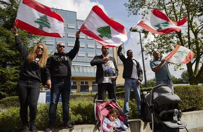 THE HAGUE, NETHERLANDS - AUGUST 18: Supporters of former Prime Minister Rafiq Hariri wave Lebanese flags outside the Lebanon Tribunal on August 18, 2020 in The Hague, Netherlands. The Special Tribunal for Lebanon must render its verdict on the trial of four men accused of participating in the 2005 assassination of former Lebanese Prime Minister Rafic Hariri. (Photo by Pierre Crom/Getty Images)