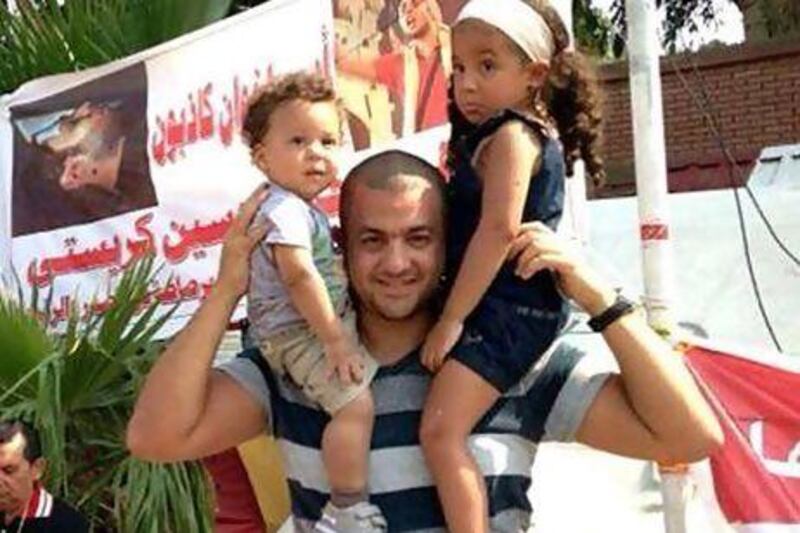Hossam Bedewy Sadek with his son Malik, age 1, and daughter Lily, age 4. Muslim Brotherhood claimed he was one of their “martyrs”, but his family says he opposed the group. Photo courtesy Karim Bedewy Sadek
