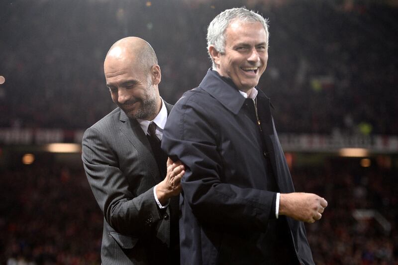 Manchester United's Portuguese manager Jose Mourinho (R) and Manchester City's Spanish manager Pep Guardiola share a joke ahead of the EFL (English Football League) Cup fourth round match between Manchester United and Manchester City at Old Trafford in Manchester, north west England on October 26, 2016. / AFP PHOTO / Oli SCARFF / RESTRICTED TO EDITORIAL USE. No use with unauthorized audio, video, data, fixture lists, club/league logos or 'live' services. Online in-match use limited to 75 images, no video emulation. No use in betting, games or single club/league/player publications.  / 