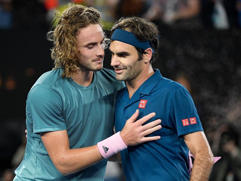 Greece's Stefanos Tsitsipas, left, is congratulated by Switzerland's Roger Federer after winning their fourth round match at the Australian Open tennis championships in Melbourne, Australia, Sunday, Jan. 20, 2019. (AP Photo/Andy Brownbill)