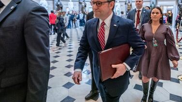 US Speaker of the House Mike Johnson walks towards the House floor ahead of a vote on the funding package. EPA