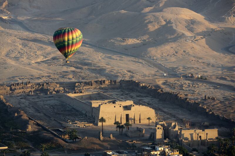 A hot-air balloon flies over the mortuary temple of Ramsis III at Medinet Habu on the west bank of the Nile River in Luxor. AP Photo