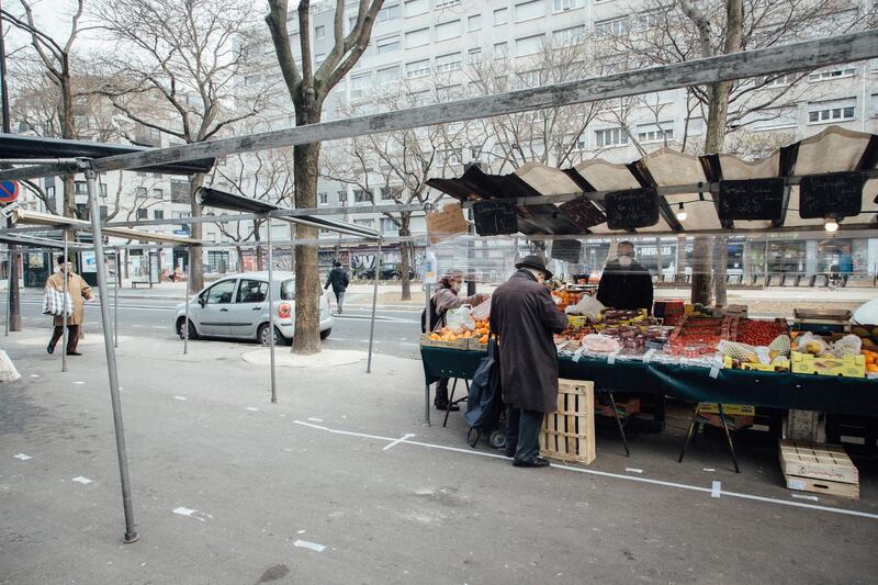 An elderly shopper wearing a protective face mask browses fruit and vegetables at a street market during coronavirus containment and movement restrictions in Paris, on March 20, 2020. Bloomberg