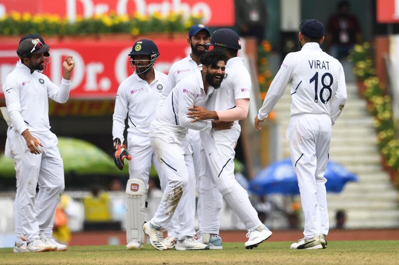 India bowler Ravindra Jadejam, centre, celebrates with teammates after bowling out South Africa's Heinrich Klaasen. AFP