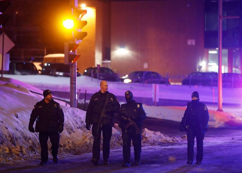 Police officers patrol the perimeter near a mosque after a shooting in Quebec City. Mathieu Belanger / Reuters

