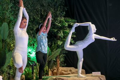 Visitors try to follow the lead of yoga instructors inside the India pavilion at Expo 2020 Dubai. Khushnum Bhandari / The National