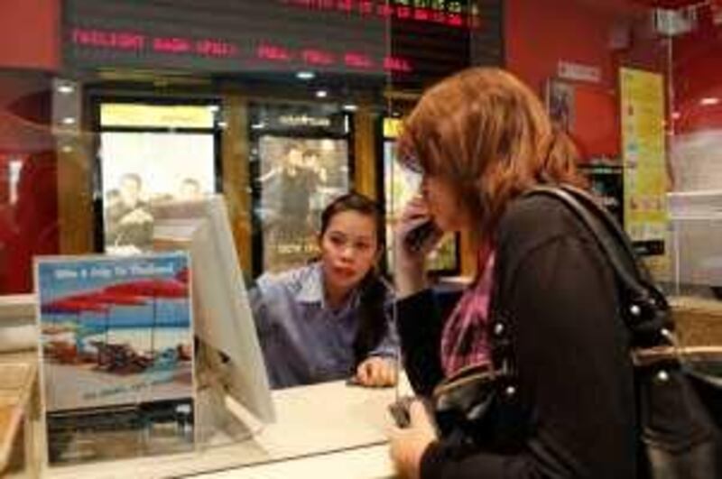 ABU DHABI, UNITED ARAB EMIRATES - November 26, 2009: Aya Yasser, 16, purchases a ticket to see "The Twilight Saga, New Moon" at Marina Mall in Abu Dhabi.
( Ryan Carter / The National )

 *** Local Caption ***  RC003-NewMoon-20091126.jpg