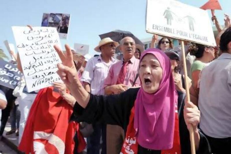 A Tunisian woman holds a sign reading "Together for Equality" during a protest calling for the respect of women's rights in front of the headquarters of the National Constituent Assembly last year. Fethi Belaid / AFP