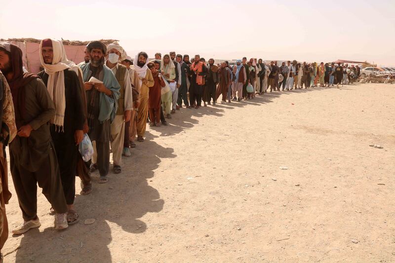 People queue to cross the Pakistan-Afghanistan border, where the Taliban victory has led to security fears. EPA