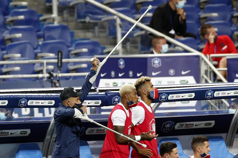 Kylian Mbappe celebrates on crutches. EPA