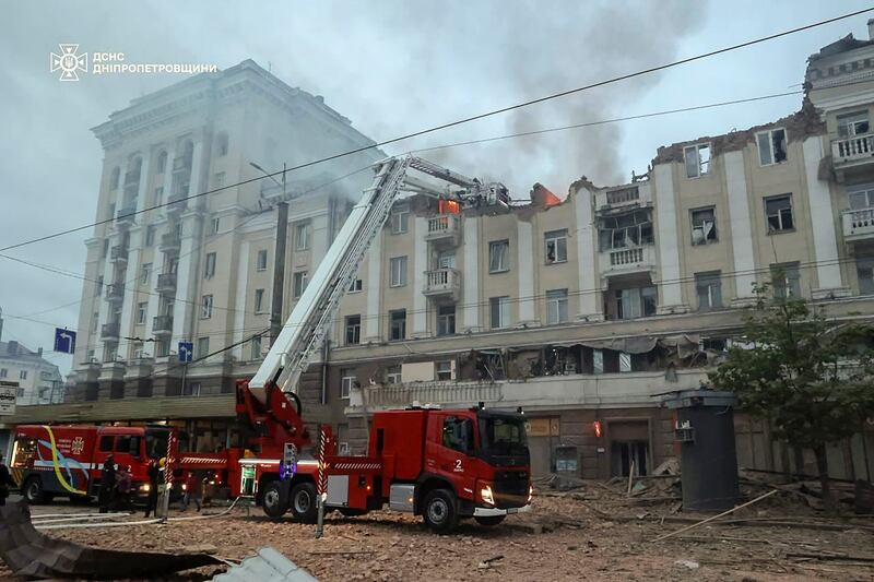 Ukrainian rescuers at the site of a rocket attack on a residential building in Dnipro, south-eastern Ukraine. EPA