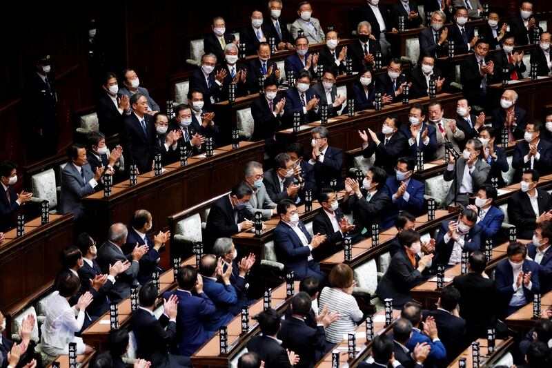 Japan's newly-elected Prime Minister Yoshihide Suga stands as he was chosen as new prime minister at the Lower House of Parliament in Tokyo. REUTERS