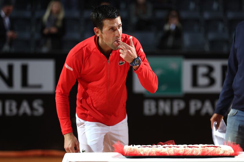 Novak Djokovic is presented with a cake after his 1000th career win following victory in the Italian Open semi-final. Getty