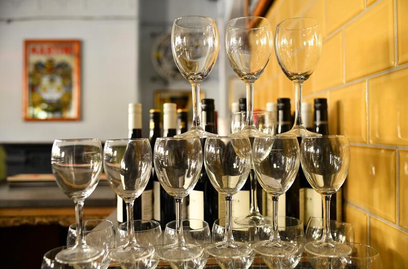 FILE PHOTO: Wine glasses are stacked inside The Greenwich Pensioner pub, which was closed to slow the spread of the coronavirus disease (COVID-19), London, Britain, May 21, 2020. Picture taken May 21, 2020.  REUTERS/Dylan Martinez/File Photo