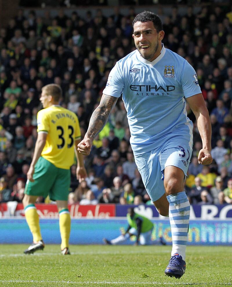 Manchester City's Argentinian striker Carlos Tevez celebrates scoring his second goal during the English Premier League football match between Norwich City and Manchester City at Carrow Road stadium in Norwich, England on April 14, 2012. AFP PHOTO/IAN KINGTON

RESTRICTED TO EDITORIAL USE. No use with unauthorized audio, video, data, fixture lists, club/league logos or “live” services. Online in-match use limited to 45 images, no video emulation. No use in betting, games or single club/league/player publications.
 *** Local Caption ***  304841-01-08.jpg
