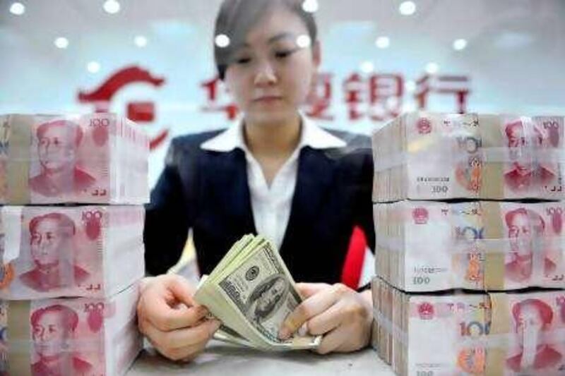 An employee counts U.S. dollar banknotes at a branch of Huaxia Bank in Shenyang, Liaoning province March 18, 2010. A rise in the yuan would be a disaster for labour-intensive Chinese exporters, a semi-official trade group said on Thursday, as frictions grow with the U.S. and other Western powers over Beijing's stable currency policy. The China Council for the Promotion of International Trade was checking with more than 1,000 exporters in 12 industries on whether they could cope with a stronger exchange rate, Zhang Wei, vice-chairman of the association, said. REUTERS/Sheng Li (CHINA - Tags: BUSINESS POLITICS) *** Local Caption ***  PEK06_CHINA-USA-YUA_0318_11.JPG *** Local Caption ***  PEK06_CHINA-USA-YUA_0318_11.JPG