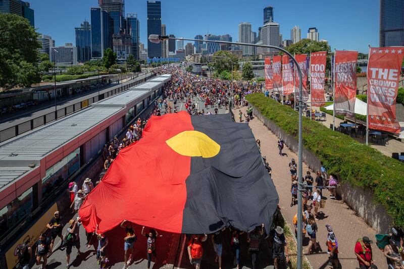 'Invasion Day' protesters march down a street during Australia Day in Brisbane. Many Indigenous groups commemorate January 26 as the invasion of their land by the British. EPA