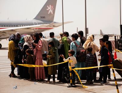 Afghan civilians prepare to board a plane at Hamid Karzai International Airport in Kabul. AP