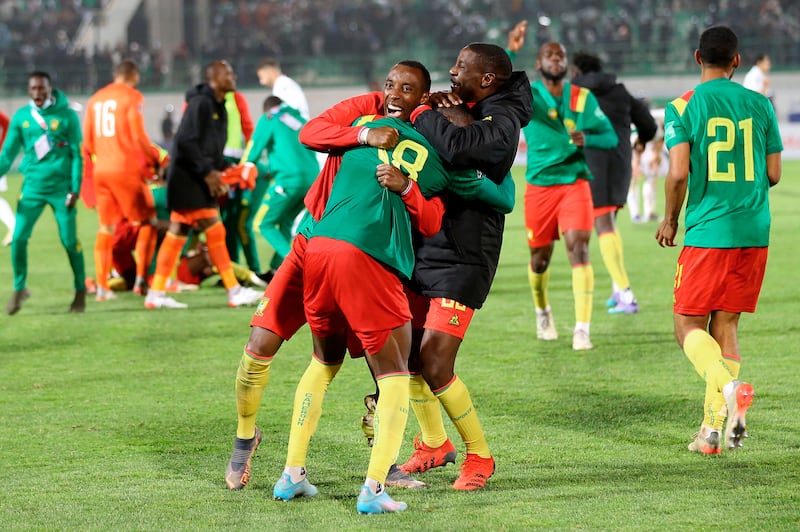 Cameroon players celebrate after beating Algeria. AP