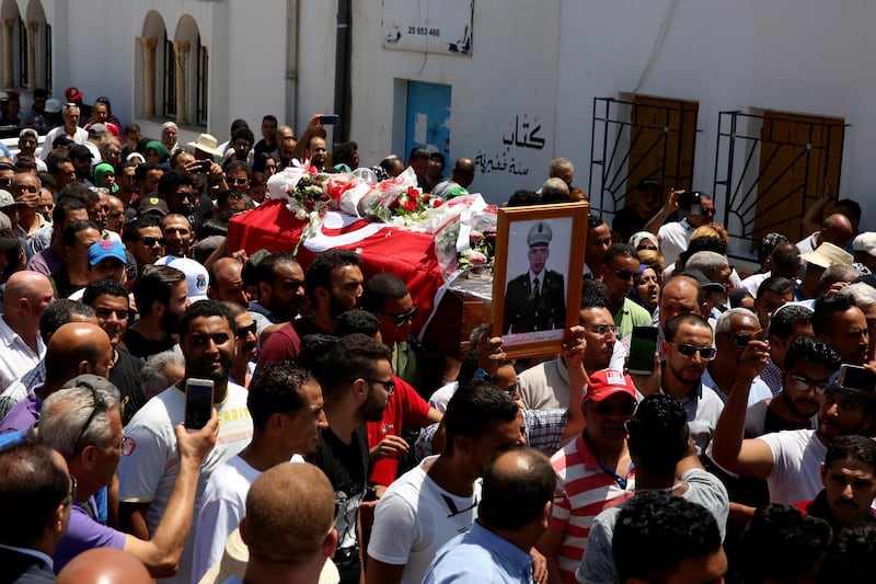 Family members and relatives attend the funeral procession of Anis Ouerghemm in Rades, south of Tunis on July 9, 2018.  At least six soldiers in Tunisia's national guard were killed July 8 in at  near the Algerian border. AP