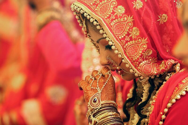A bride takes part in a mass marriage ceremony in Bhopal, India. More than 82 Muslim couples tied up the nuptial knot in the mass marriage ceremony. Sanjeev Gupta / EPA
