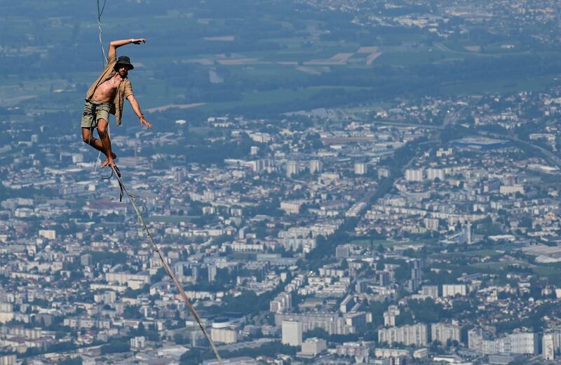 A man walks on a slackline at the European 'Marmotte Highline Project' festival in Lans-en-Vercors, near Grenoble, France. AFP