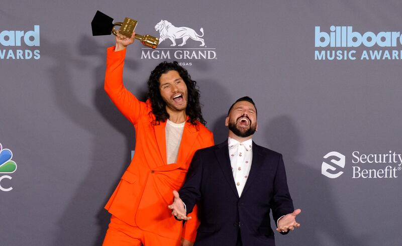 Dan Smyers, right, and Shay Mooney of musical duo Dan + Shay pose with the award for Top Country Duo/Group. AFP