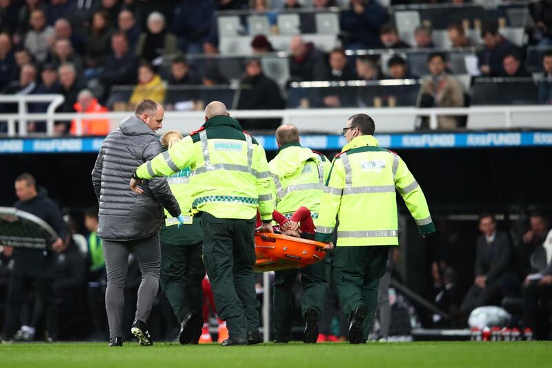Salah is carried off the pitch on a stretcher. Clive Brunskill / Getty Images