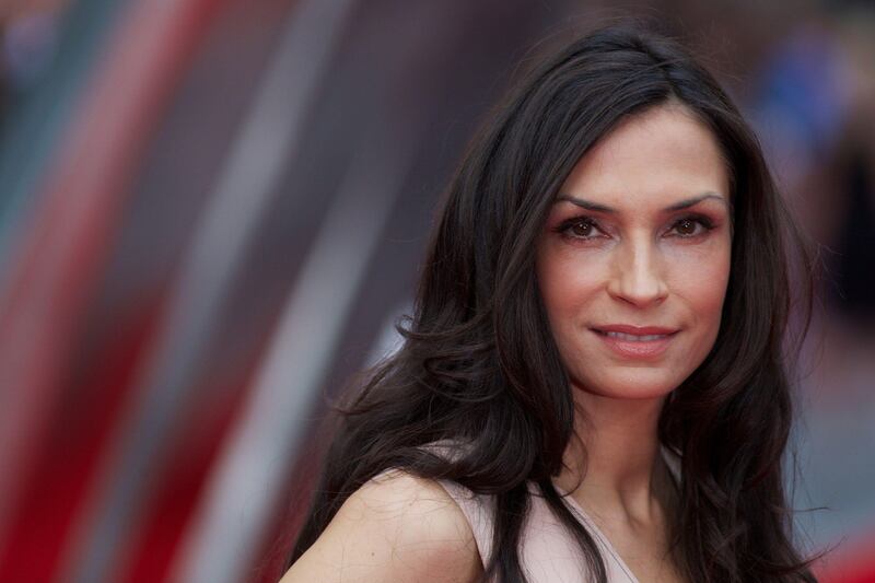 Dutch actress Famke Janssen poses for photographers on the red carpet as she arrives for the UK premier of the film 'The Wolverine' in London on July 16, 2013. AFP PHOTO/ANDREW COWIE
 *** Local Caption ***  561477-01-08.jpg