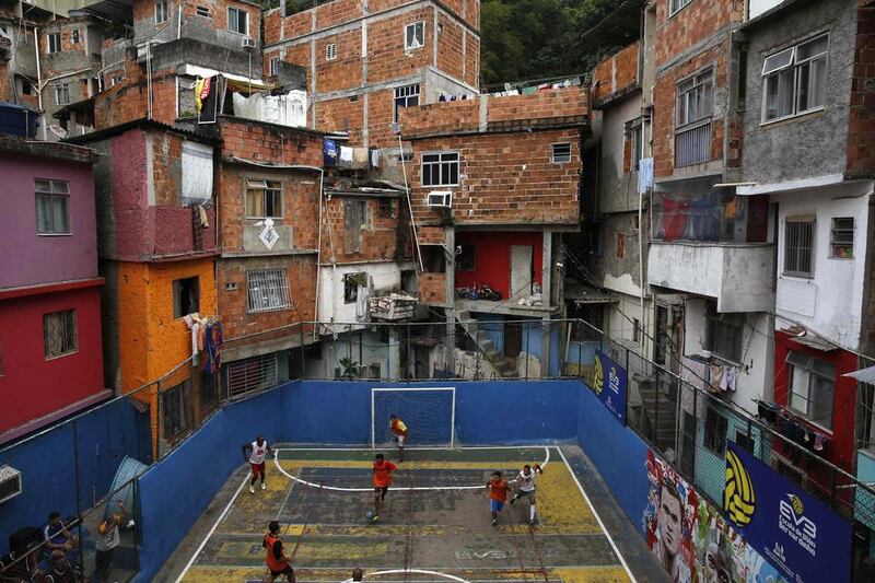 People take part in a football match held at the Tavares Bastos slum in Rio de Janeiro. The World Cup will be held in 12 cities in Brazil from June 12 till July 13. Pilar Olivares / Reuters