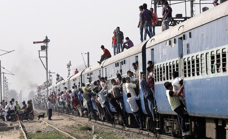 Indian passengers hang and sit on an overcrowded train as it departs from Loni town, in Uttar Pradesh on February 26. EPA