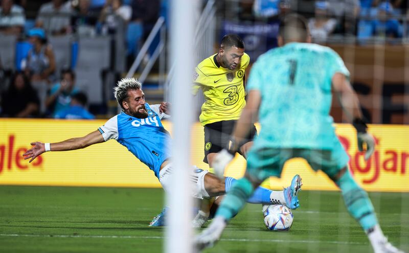 Charlotte defender Guzman Corujo slide tackles Chelsea midfielder Hakim Ziyech. AP