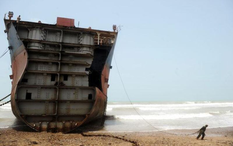 Coming to rest: A ship sits on the beach partially dismantled.