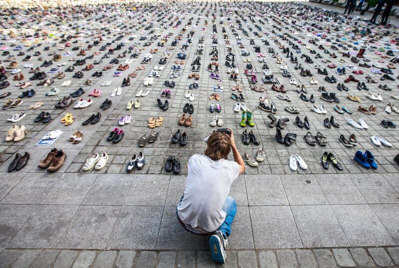 A man takes photos of the Place Jean Rey in front of the EU Council covered by 4,500 empty pairs of shoes to memorialize every person killed in the Israel over the last decade, in Brussels, Belgium. The installation greeted European Foreign Ministers as they entered a one day meeting to discuss the ongoing Gaza crisis and other international topics.  Stephanie Lecocq / EPA