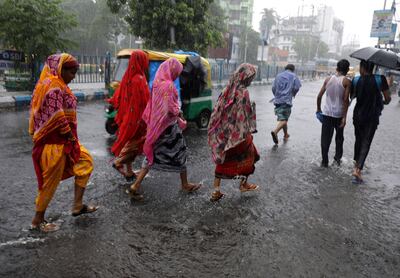 Commuters during a heavy shower in Kolkata, India, on May 10, 2022.  EPA