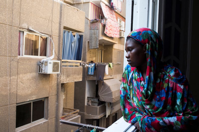 Abukk Sebit, 25, looks from her balcony after working to help financially her family in Sudan, at Ain Shams district area in Cairo, Egypt September 13, 2022. Reuters