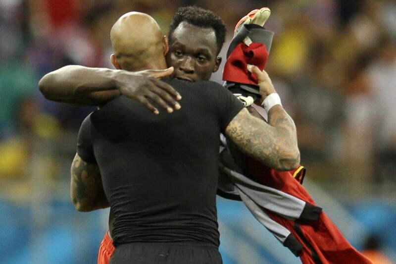 Tim Howard and Romelu Lukaku embrace following the Lukaku and Belgium's win over Howard and the United States on Tuesday at the 2014 World Cup round of 16. Natacha Pisarenko / AP