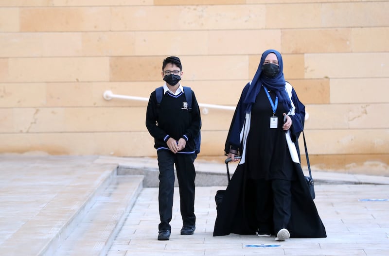 A young pupil prepares to reunite with classmates at Brighton College . Chris Whiteoak / The National