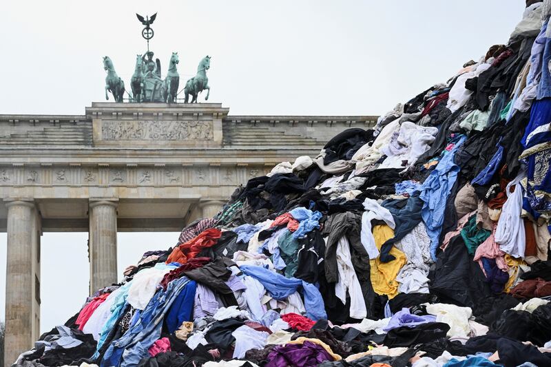 Greenpeace activists protest on the first day of Berlin Fashion Week with "a mountain" of textile waste from a second hand market in Accra, Ghana, against the pollution of the environment caused by fast fashion clothes as plastic waste, in front of the Brandenburg gate, in Berlin, Germany. Reuters