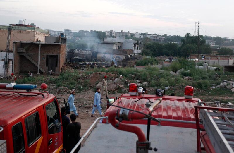 Army troops cordon-off surrounding area of the plane crash site. AP Photo