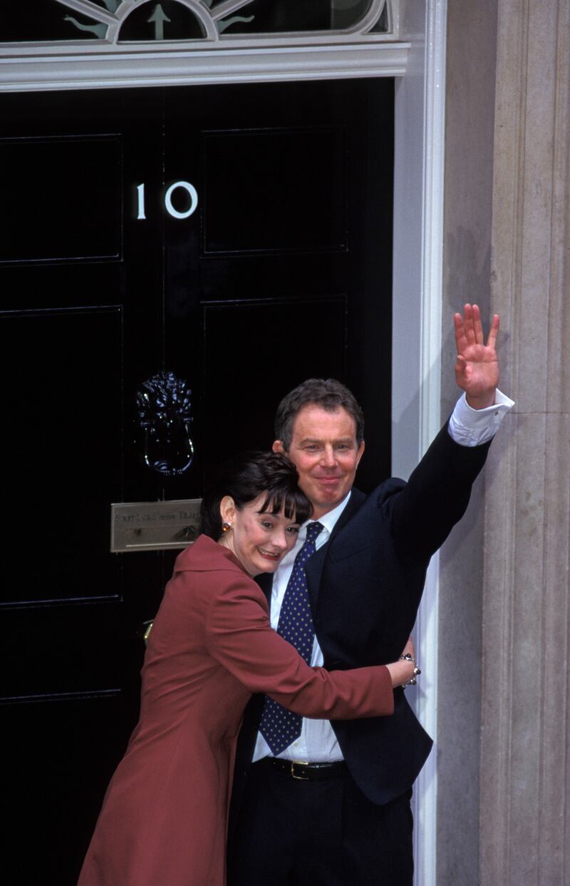 Newly elected Labour prime minister Tony Blair stands on the steps of No 10 Downing Street with his wife Cherie in 1997
