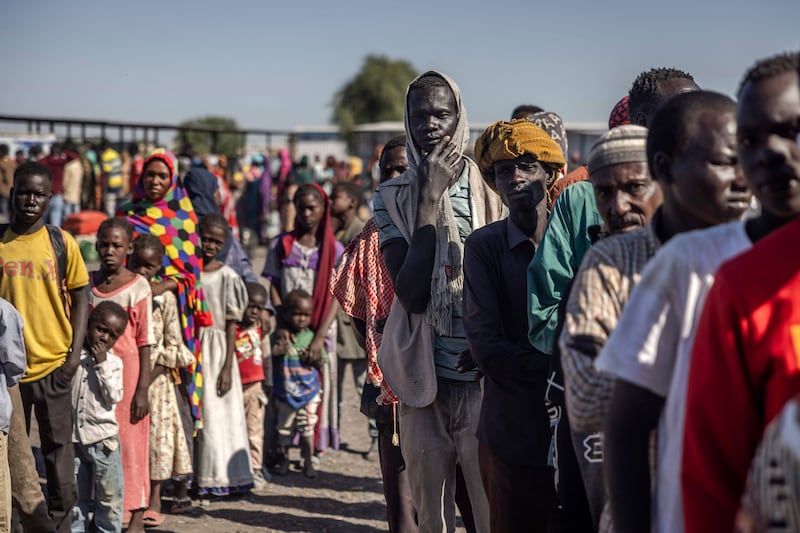 Sudanese refugees queue to board a lorry to go to a transit centre after crossing the border into South Sudan on February 14. AFP