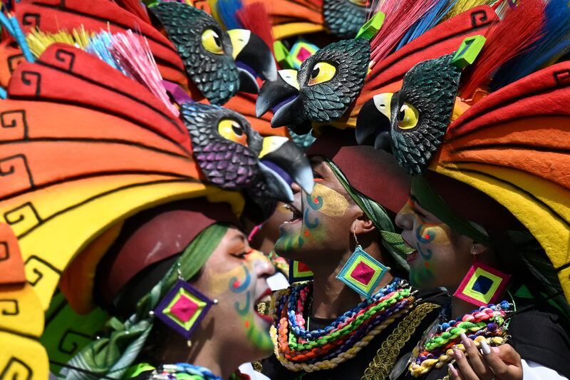 Revellers take part in the Chant to the Earth parade during the Carnival of Blacks and Whites in Pasto, Colombia. AFP