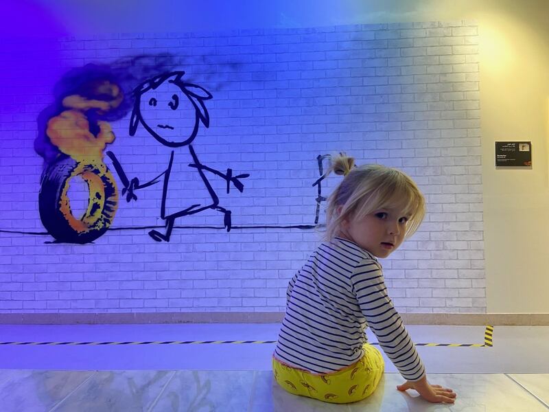 The mural of a stick girl chasing a burning tyre was drawn on the wall of Bridge Farm Primary school in Bristol, England as a gift from the artist after the school named a building after him. Gemma White