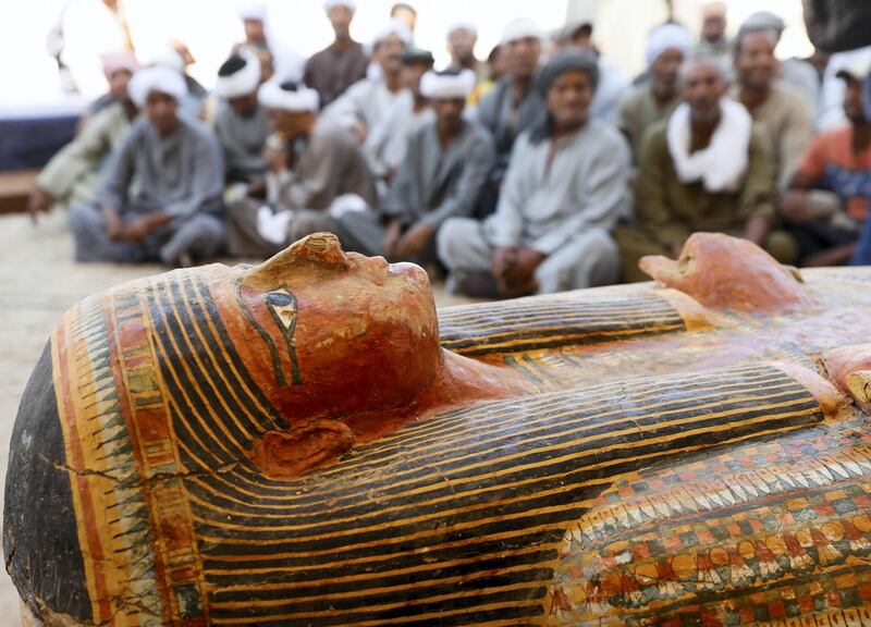 Excavators sit behind painted ancient coffins at Al-Asasif necropolis, unveiled by Egyptian antiquities officials in the Valley of the Kings in Luxor, Egypt October 19, 2019. REUTERS/Mohamed Abd El Ghany