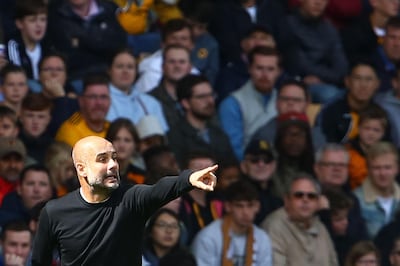 Manchester City's Spanish manager Pep Guardiola gestures from the touchline during the English Premier League football match between Wolverhampton Wanderers and Manchester City at the Molineux stadium in Wolverhampton, central England on August 25, 2018. (Photo by GEOFF CADDICK / AFP) / RESTRICTED TO EDITORIAL USE. No use with unauthorized audio, video, data, fixture lists, club/league logos or 'live' services. Online in-match use limited to 120 images. An additional 40 images may be used in extra time. No video emulation. Social media in-match use limited to 120 images. An additional 40 images may be used in extra time. No use in betting publications, games or single club/league/player publications. / 